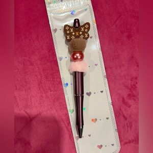 LV pen with pom pom